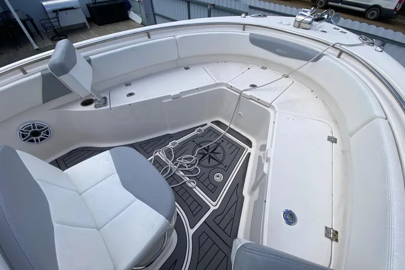 Slide: The Image of 2022 Robalo R242 Center Console boat interior with seating and storage compartments. - 35