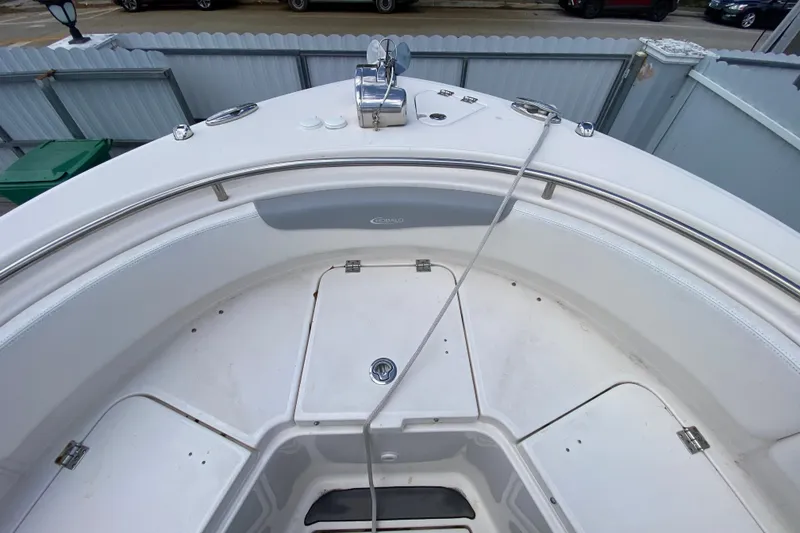 Slide: The Image of 2022 Robalo R242 Center Console boat interior with stainless steel railings and storage compartments. - 36