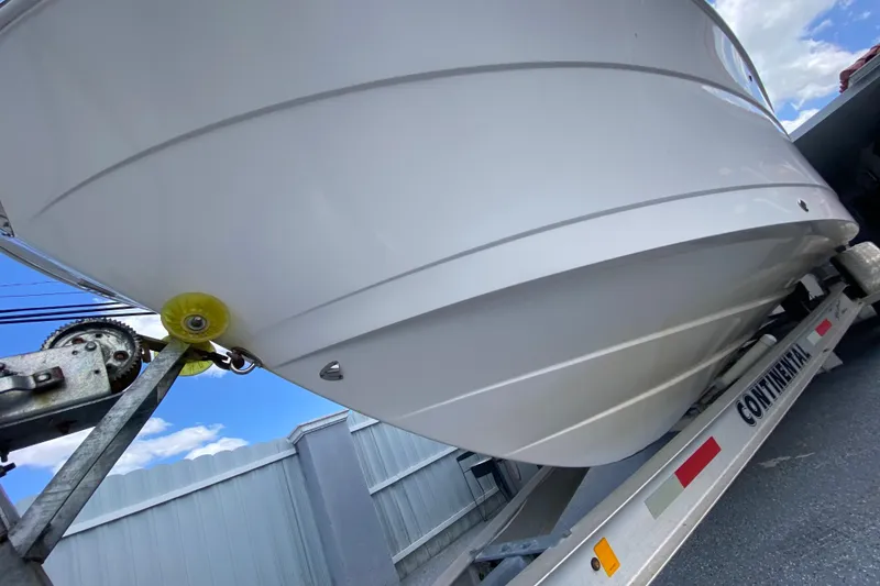 Slide: The Image of 2022 Robalo R242 Center Console boat on trailer, viewed from below. - 4