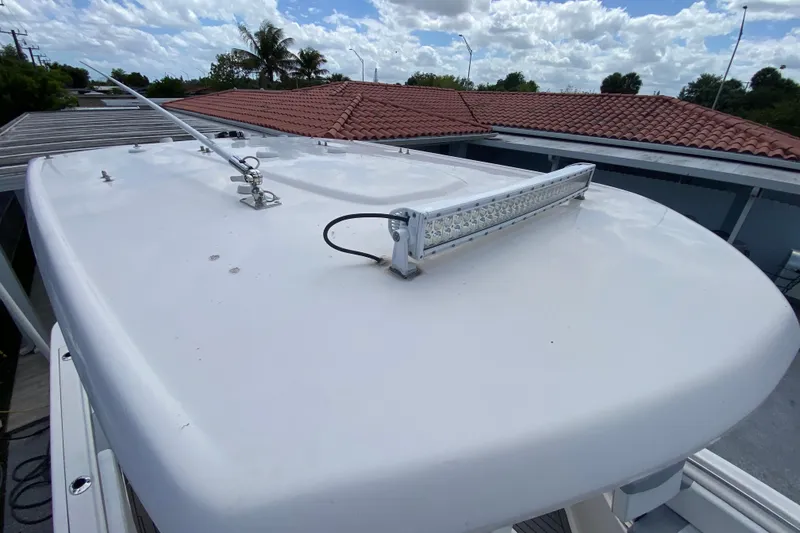 Slide: The Image of Robalo R242 Center Console 2022 boat roof with mounted light bar and antenna. - 49