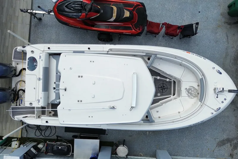 Slide: The Image of Overhead view of 2022 Robalo R242 Center Console boat docked beside a jet ski. - 50