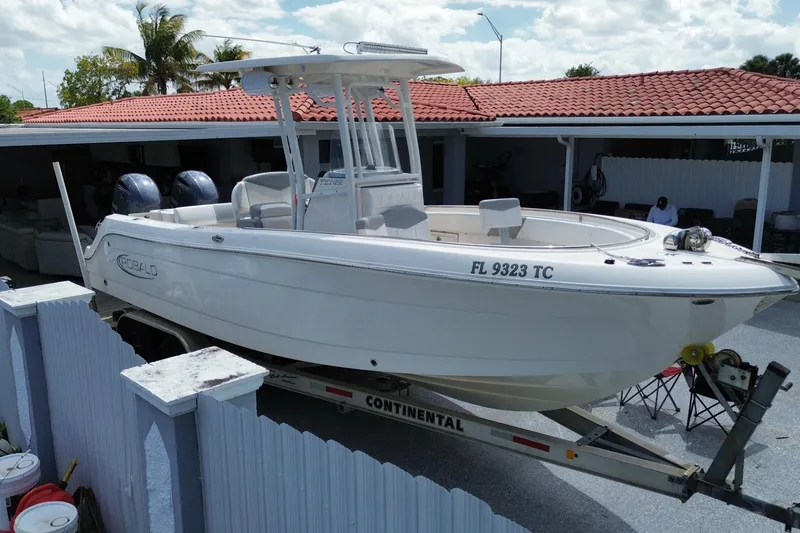 Slide: The Image of 2022 Robalo R242 Center Console boat on trailer, parked in driveway. - 8