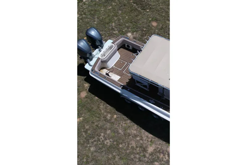 Slide: The Image of Aerial view of 2007 Dusky 33 Open Fisherman boat with twin engines on grass. - 10