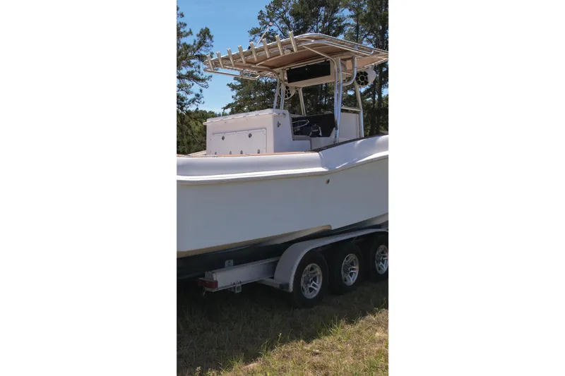 Slide: The Image of 2007 Dusky 33 Open Fisherman boat on trailer, parked outdoors. - 5