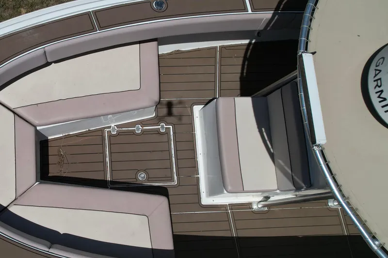 Slide: The Image of Dusky 33 Open Fisherman 2007 boat interior with cushioned seating and Garmin equipment. - 6