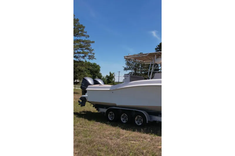 Slide: The Image of 2007 Dusky 33 Open Fisherman boat on trailer under clear blue sky. - 9