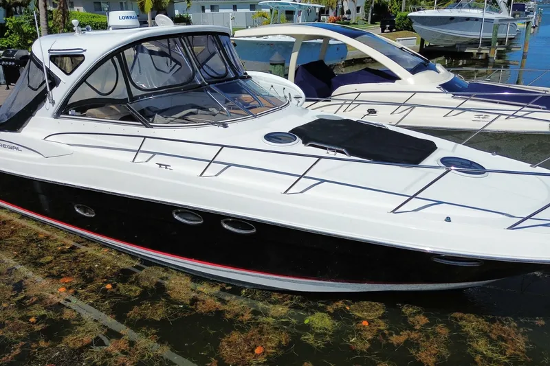 Slide: The Image of 2006 Regal Commodore 3560 IB yacht docked in a marina, showcasing sleek design. - 10