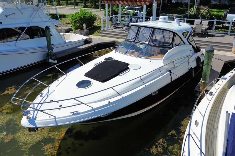 Slide: The Image of 2006 Regal Commodore 3560 IB yacht docked at marina, featuring sleek design and spacious deck. - 11