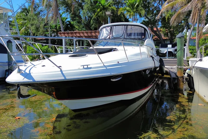 Slide: The Image of 2006 Regal Commodore 3560 IB yacht docked in a tropical marina setting. - 13