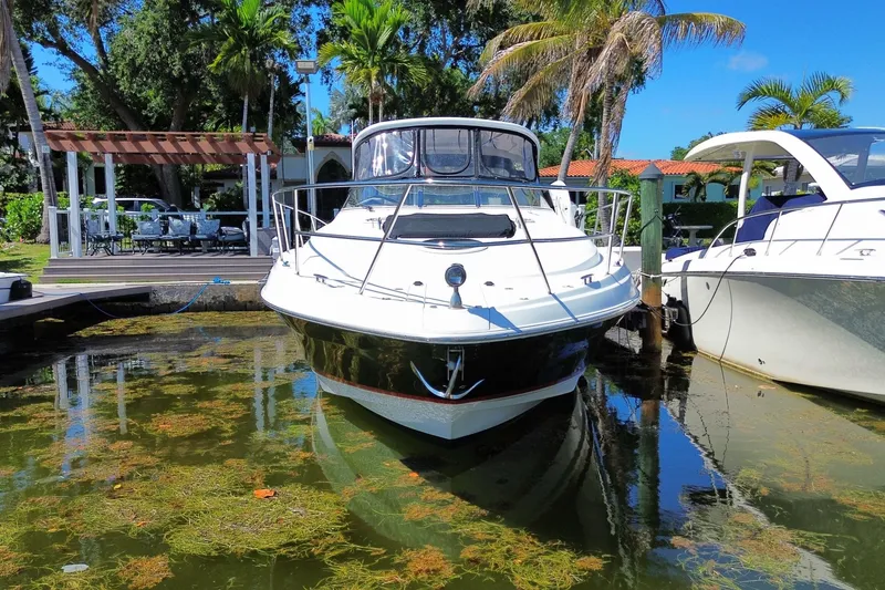Slide: The Image of 2006 Regal Commodore 3560 IB yacht docked in a tropical marina setting. - 14