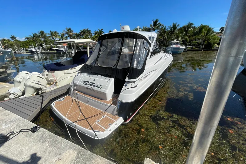 Slide: The Image of 2006 Regal Commodore 3560 IB docked in a scenic marina setting. - 17