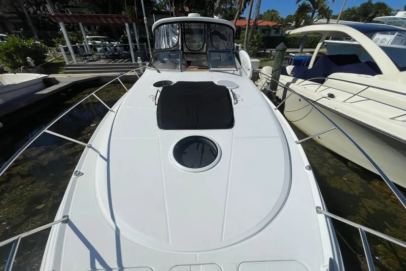 Slide: The Image of 2006 Regal Commodore 3560 IB yacht docked, showcasing sleek design and spacious deck. - 21