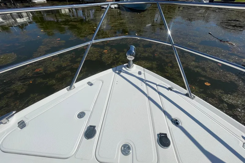 Slide: The Image of Bow of 2006 Regal Commodore 3560 IB boat on calm water. - 24