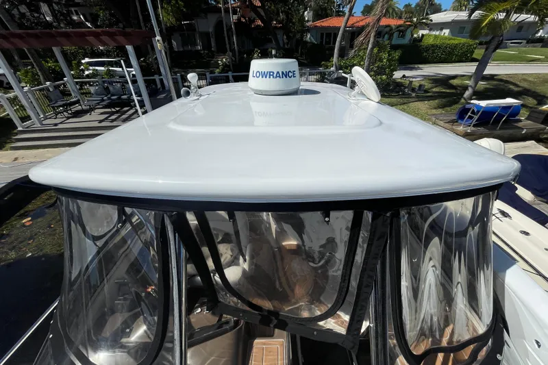 Slide: The Image of 2006 Regal Commodore 3560 IB boat with Lowrance radar, docked near a waterfront property. - 26