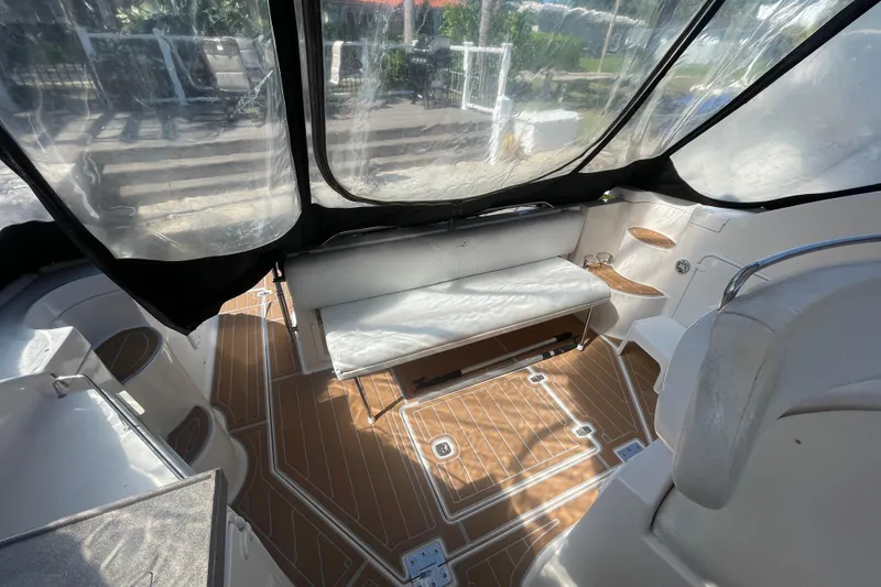 Slide: The Image of Interior of a 2006 Regal Commodore 3560 IB boat with seating and wood-patterned flooring. - 27