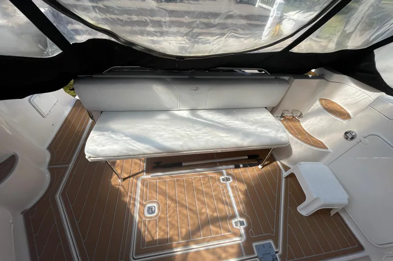 Slide: The Image of 2006 Regal Commodore 3560 IB boat interior with cushioned seating and teak-style flooring. - 31