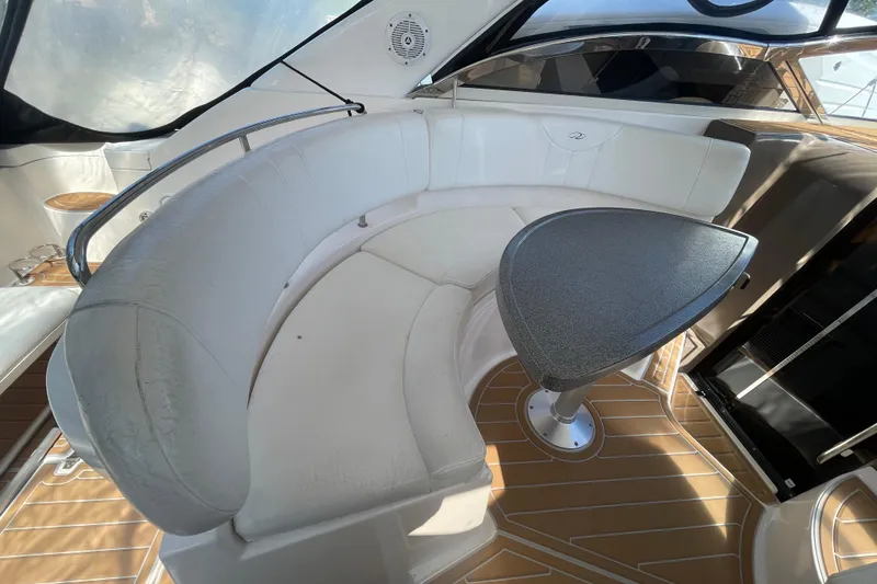 Slide: The Image of 2006 Regal Commodore 3560 IB yacht interior with curved seating and table. - 32