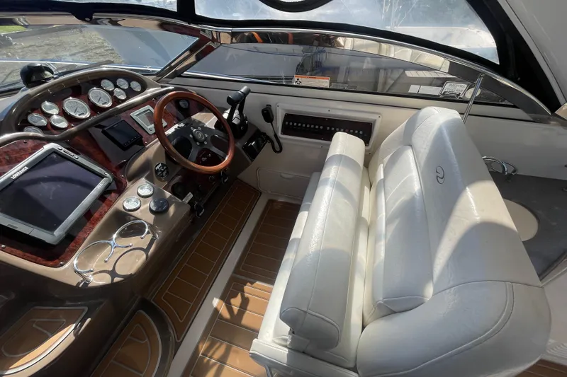 Slide: The Image of 2006 Regal Commodore 3560 IB cockpit with steering wheel, gauges, and white seating. - 33