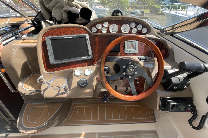 Slide: The Image of Helm of 2006 Regal Commodore 3560 IB with wood steering wheel and navigation instruments. - 34