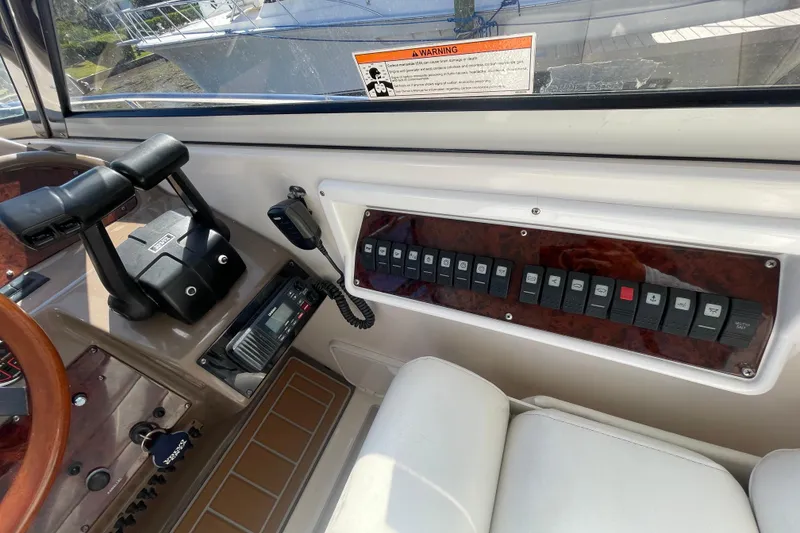 Slide: The Image of Control panel of a 2006 Regal Commodore 3560 IB boat with switches and radio. - 35