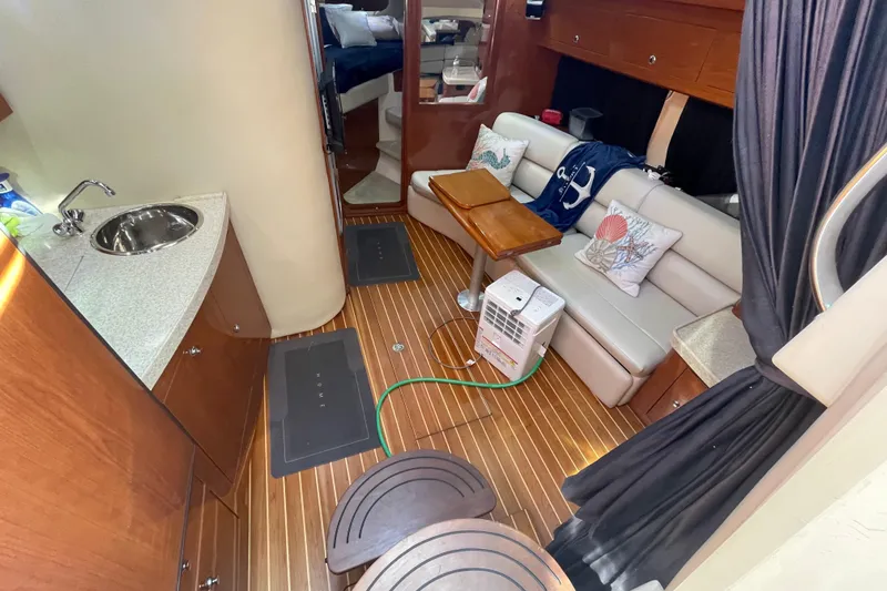 Slide: The Image of Interior of 2006 Regal Commodore 3560 IB yacht with cozy seating and kitchenette. - 41