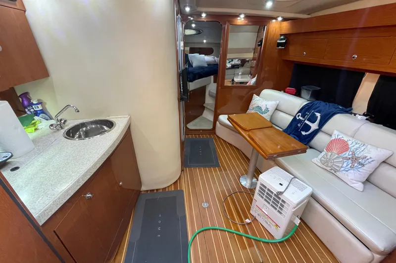 Slide: The Image of Interior of 2006 Regal Commodore 3560 IB yacht with kitchenette and seating area. - 42