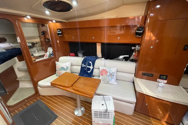 Slide: The Image of Interior of 2006 Regal Commodore 3560 IB yacht with cozy seating and wooden finishes. - 43