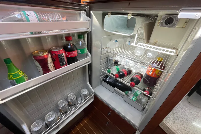 Slide: The Image of Refrigerator stocked with beverages inside a 2006 Regal Commodore 3560 IB yacht. - 44