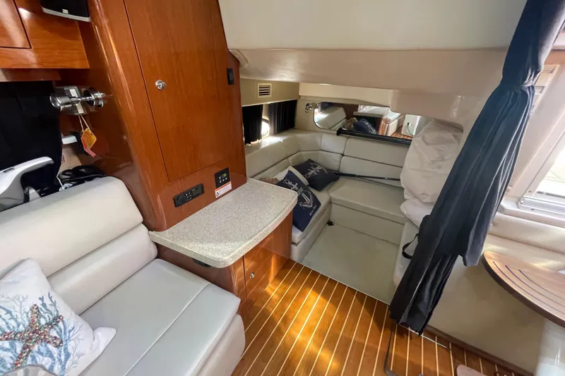 Slide: The Image of Interior of 2006 Regal Commodore 3560 IB yacht with cozy seating and wooden cabinetry. - 48