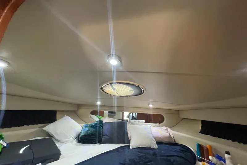 Slide: The Image of Interior cabin of 2006 Regal Commodore 3560 IB yacht with cozy bedding and ambient lighting. - 51