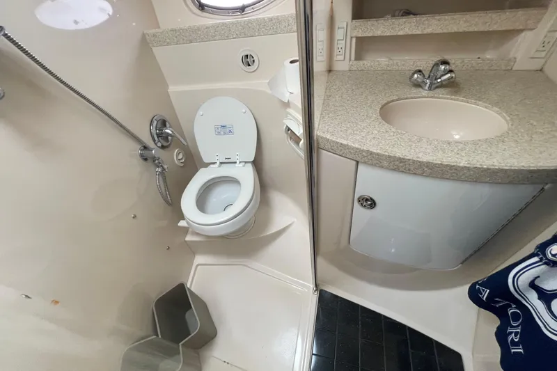 Slide: The Image of Bathroom interior of 2006 Regal Commodore 3560 IB yacht, featuring toilet and sink. - 52