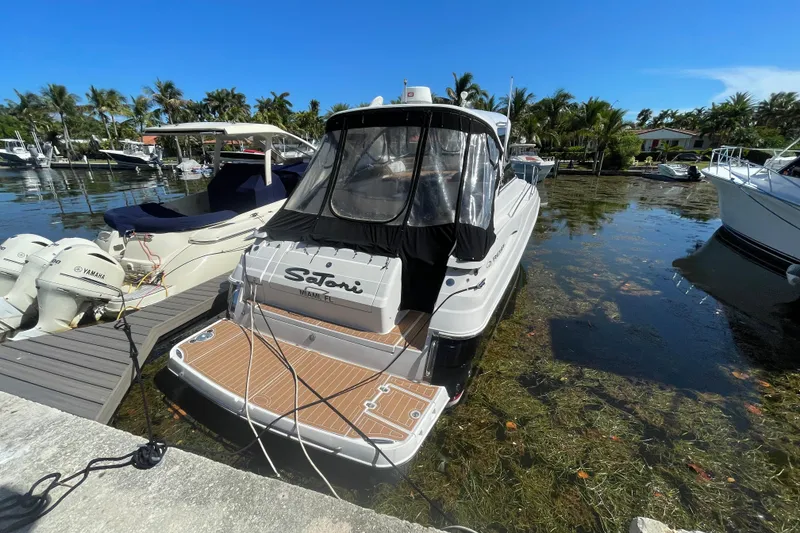 Slide: The Image of 2006 Regal Commodore 3560 IB docked in a scenic marina setting. - 55