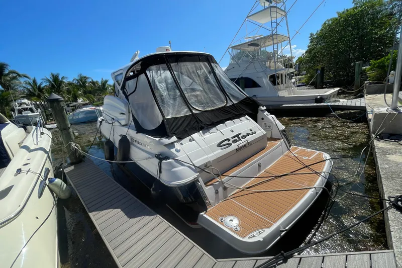 Slide: The Image of 2006 Regal Commodore 3560 IB yacht docked at marina under clear blue sky. - 57