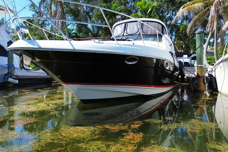 Slide: The Image of 2006 Regal Commodore 3560 IB yacht docked in a lush marina setting. - 6