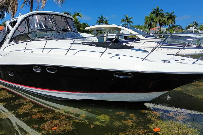 Slide: The Image of 2006 Regal Commodore 3560 IB yacht docked in a sunny marina setting. - 9