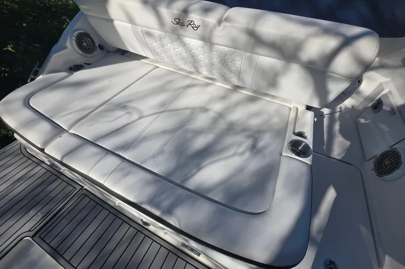 Slide: The Image of 2018 Sea Ray SDX 250 boat with white cushioned seating and integrated speakers. - 10