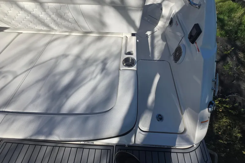 Slide: The Image of 2018 Sea Ray SDX 250 boat interior with white seating and cup holders. - 11