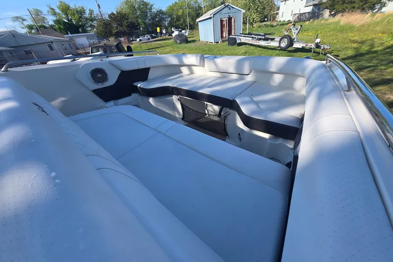 Slide: The Image of Interior view of 2018 Sea Ray SDX 250 boat with white seating and speaker. - 14