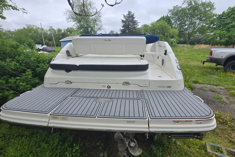 Slide: The Image of 2018 Sea Ray SDX 250 boat with spacious rear deck in a grassy area. - 17