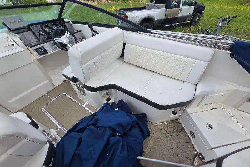 Slide: The Image of Interior of 2018 Sea Ray SDX 250 boat with white seating and dashboard. - 26