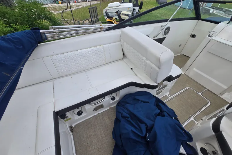Slide: The Image of 2018 Sea Ray SDX 250 boat interior with white seating and blue cover. - 27