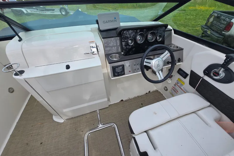 Slide: The Image of 2018 Sea Ray SDX 250 boat cockpit with Garmin navigation system and steering wheel. - 30