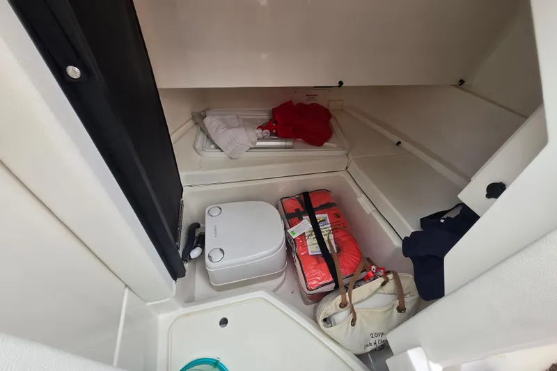 Slide: The Image of Man working inside a 2018 Sea Ray SDX 250 boat cockpit. - 31