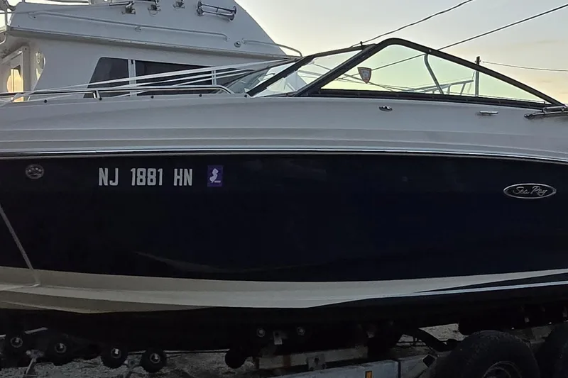 Slide: The Image of 2018 Sea Ray SDX 250 boat on trailer, side view with registration number visible. - 4