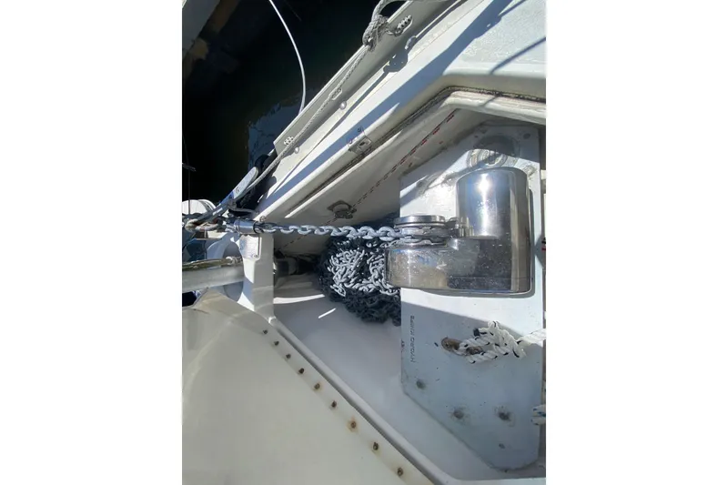 Slide: The Image of Anchor chain and windlass on a 1995 Hunter 33.5 sailboat deck. - 12