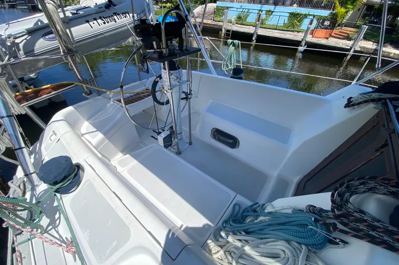 Slide: The Image of Cockpit of a 1995 Hunter 33.5 sailboat with steering wheel and ropes. - 16