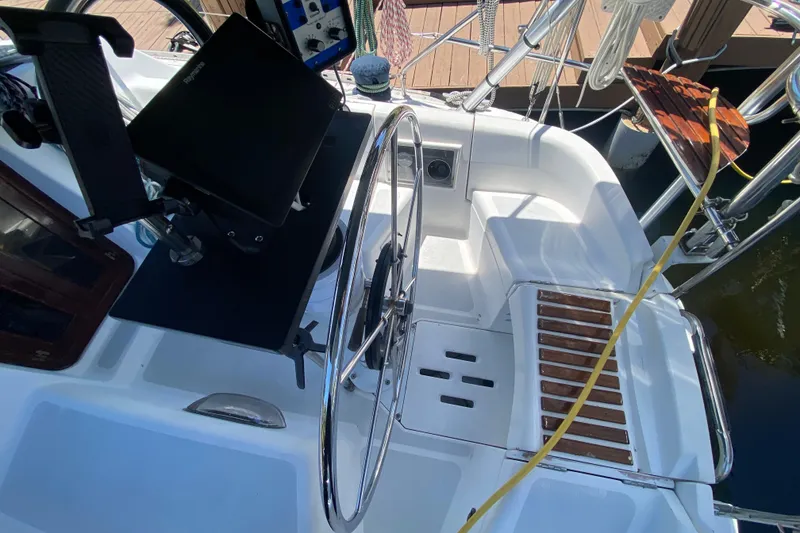 Slide: The Image of Cockpit of a 1995 Hunter 33.5 sailboat with steering wheel and navigation equipment. - 18