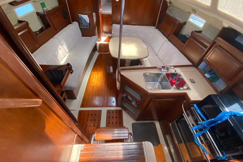 Slide: The Image of Interior of a 1995 Hunter 33.5 sailboat with wood finish and cozy seating. - 22