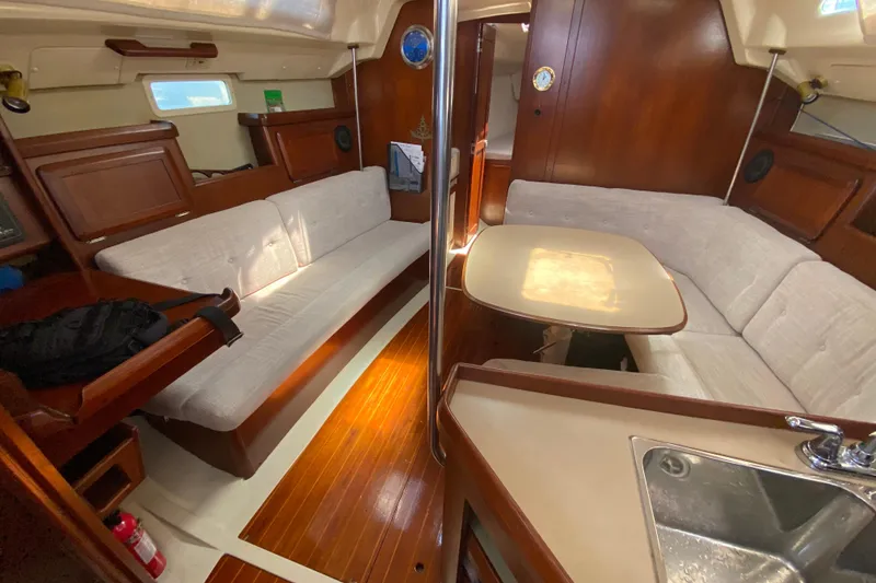 Slide: The Image of Interior of a 1995 Hunter 33.5 sailboat with wooden finishes and cozy seating. - 24