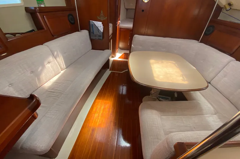 Slide: The Image of Interior of a 1995 Hunter 33.5 sailboat with cozy seating and wooden flooring. - 27